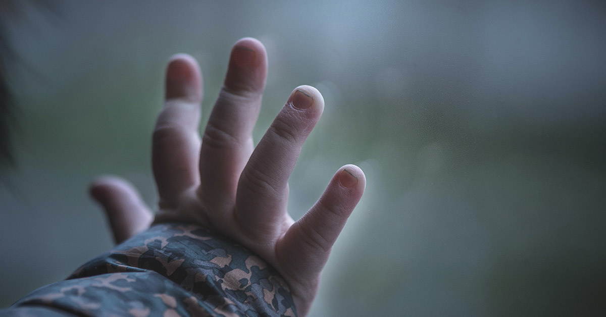 hand placed on window