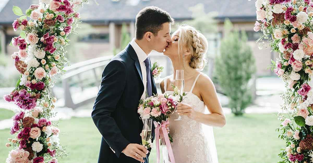 kissing bride and groom and altar