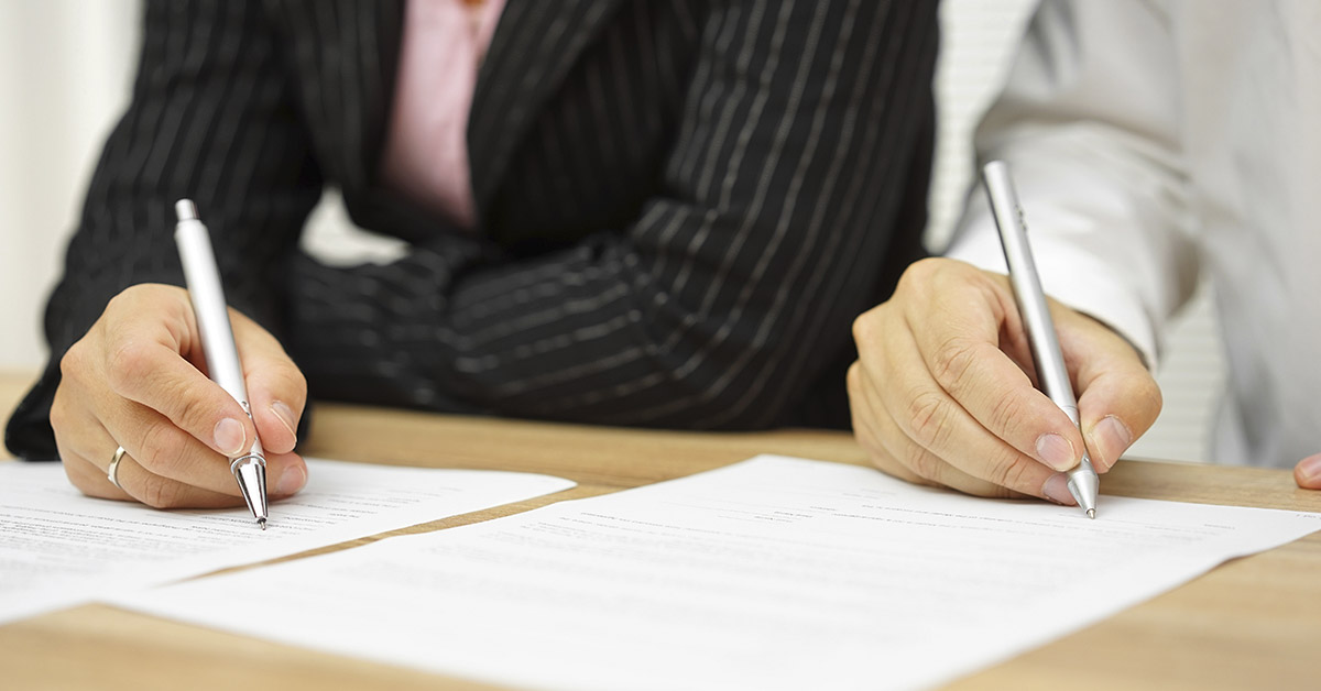 lawyers writing on documents