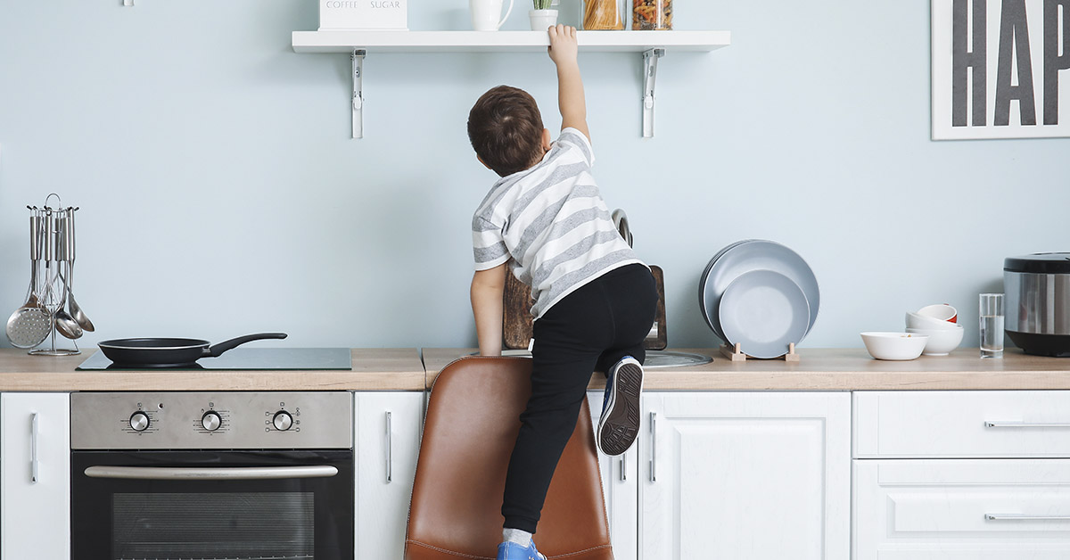 child climbing kitchen counter getting into mischief