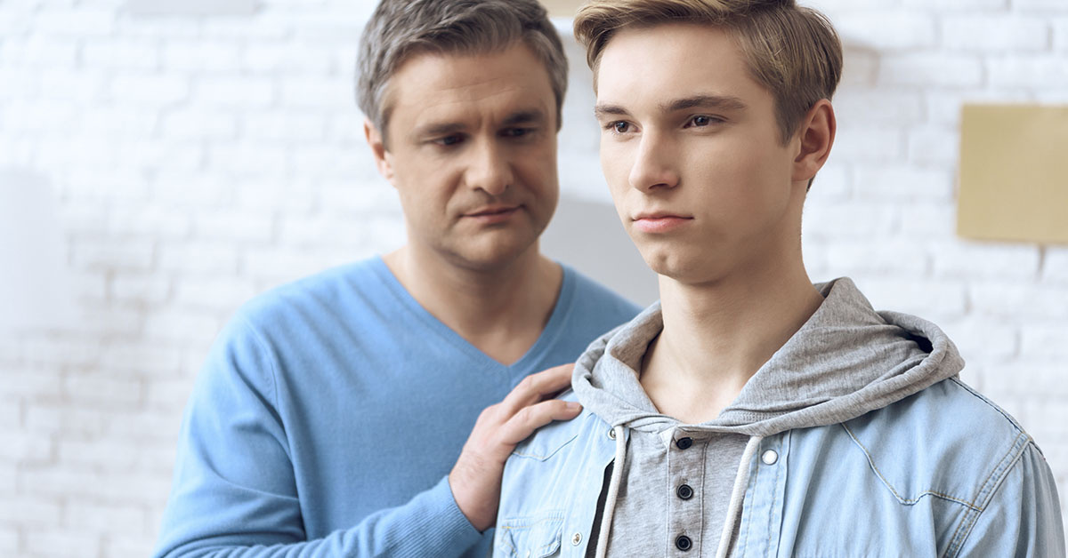 father comforting son