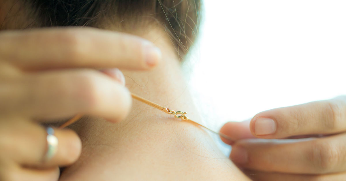 necklace being put around neck