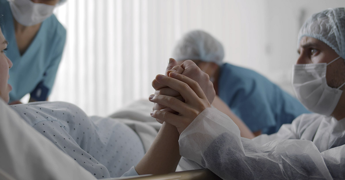 hand being held while giving birth