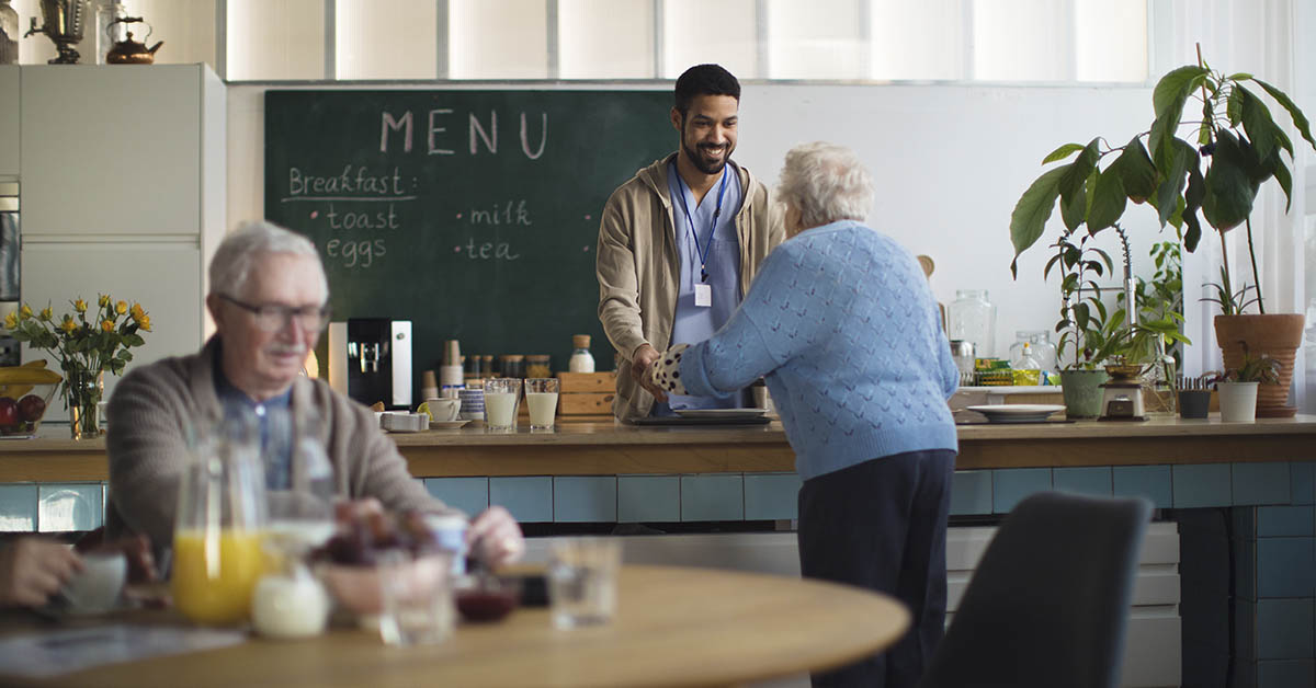 old woman at a coffee shop with younger man