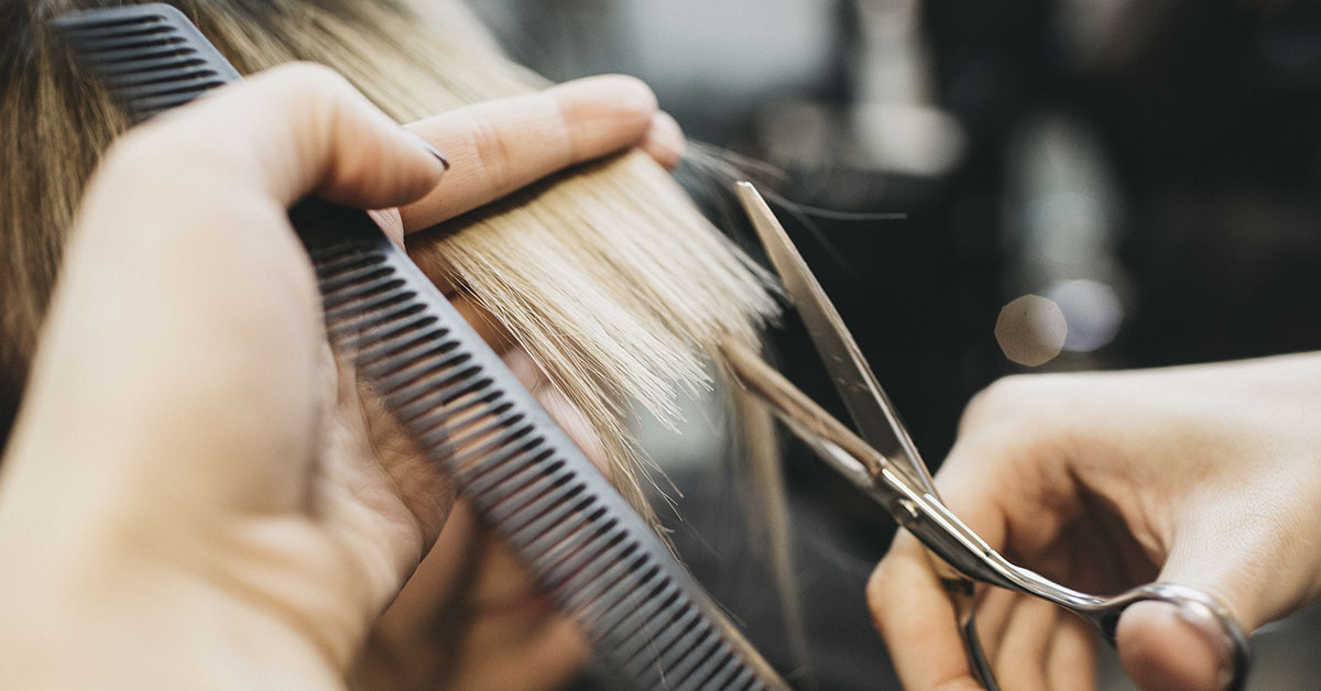 hair being clipped and styled by hairdresser