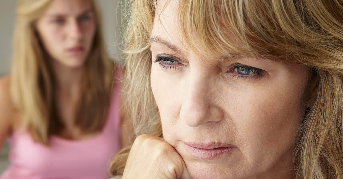 mother and daughter in argument. Mother in foreground and daughter in background