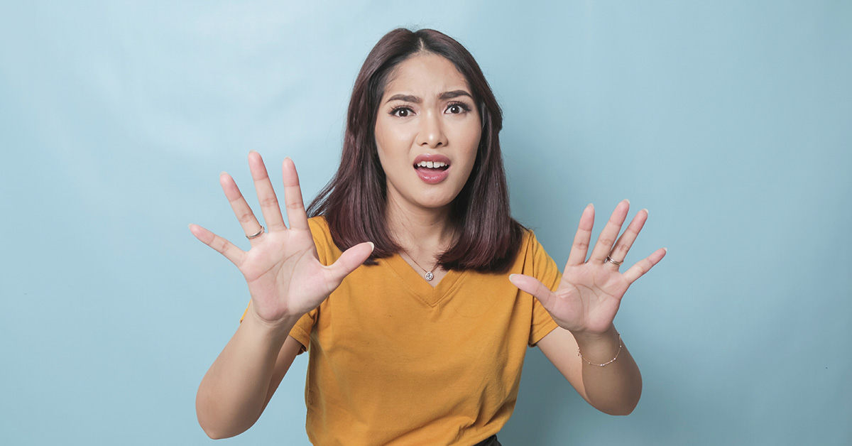 woman putting up two hands in front of her