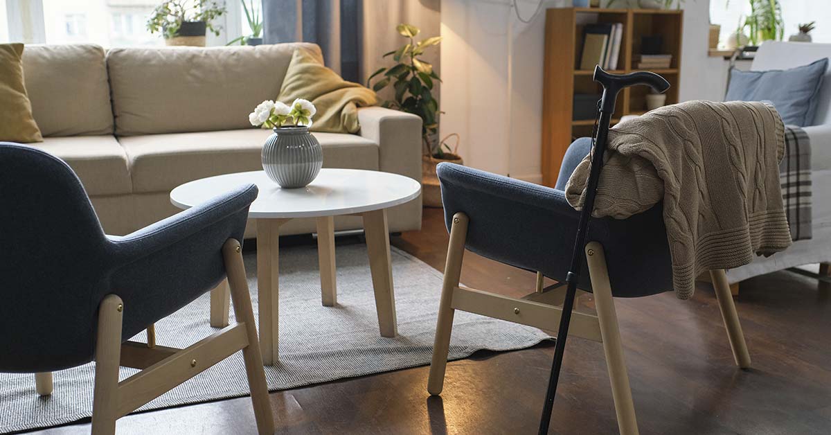 Image of modern living room with two armchairs and crutch for senior person
