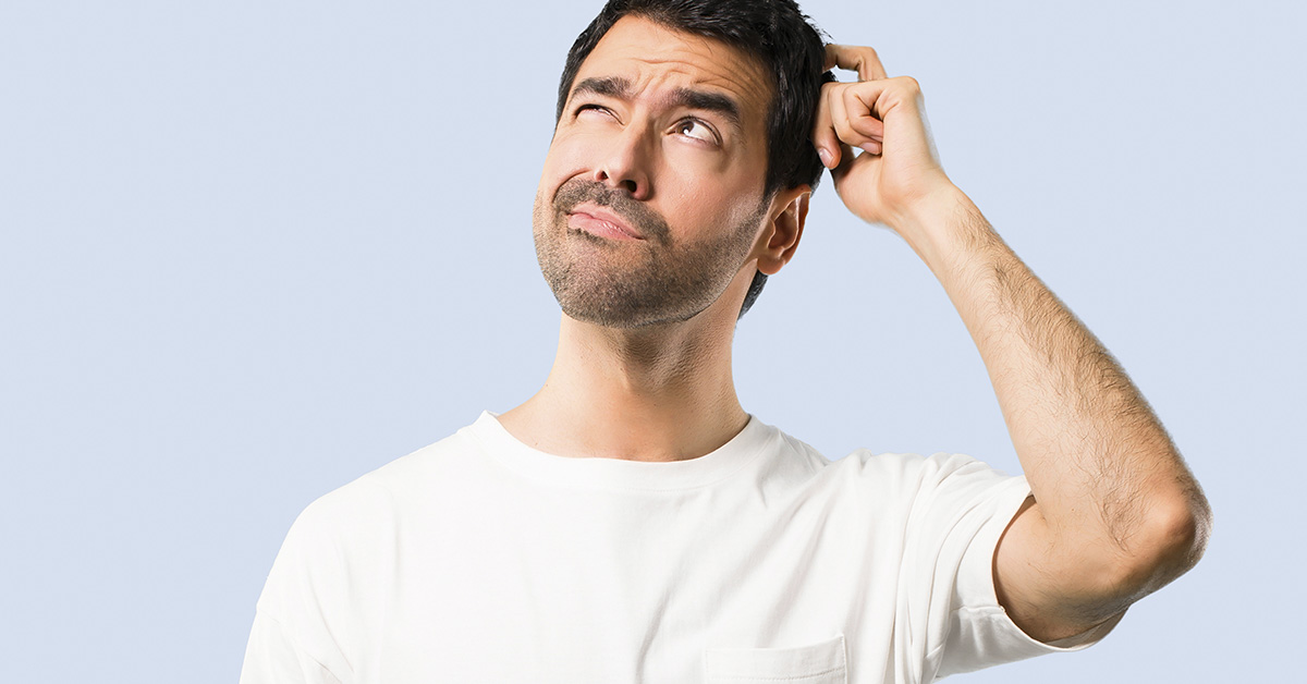 man scratching head