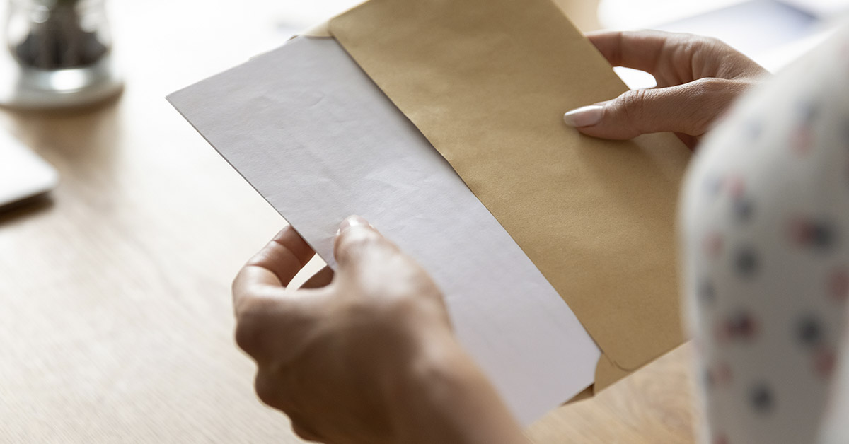 woman opening letter