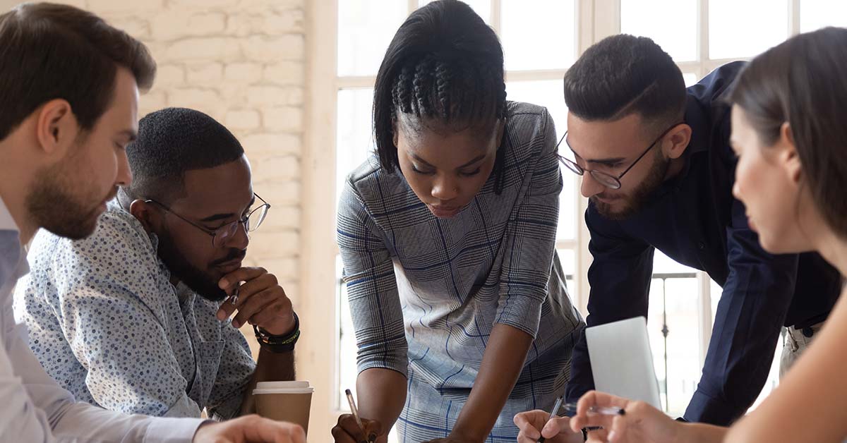 group of millennial aged people working together in office setting