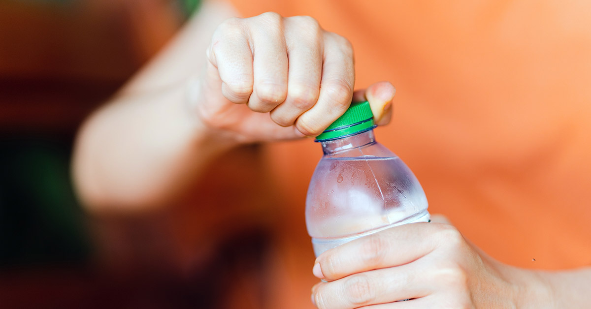 person opening bottled water