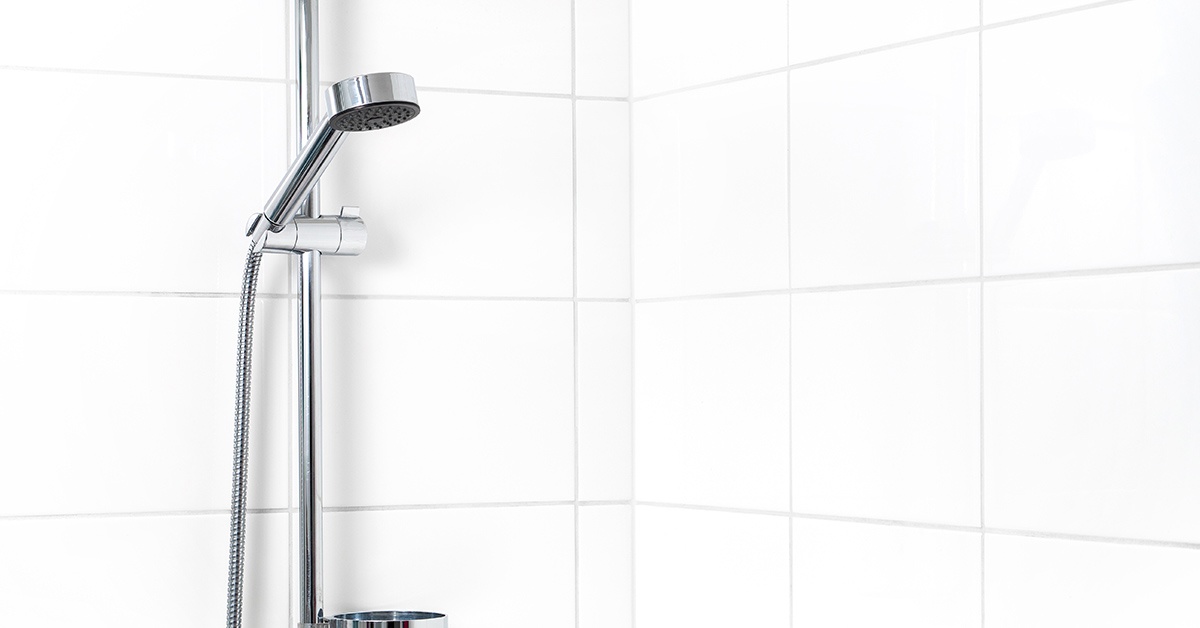white shower with chrome stainless steel fixtures