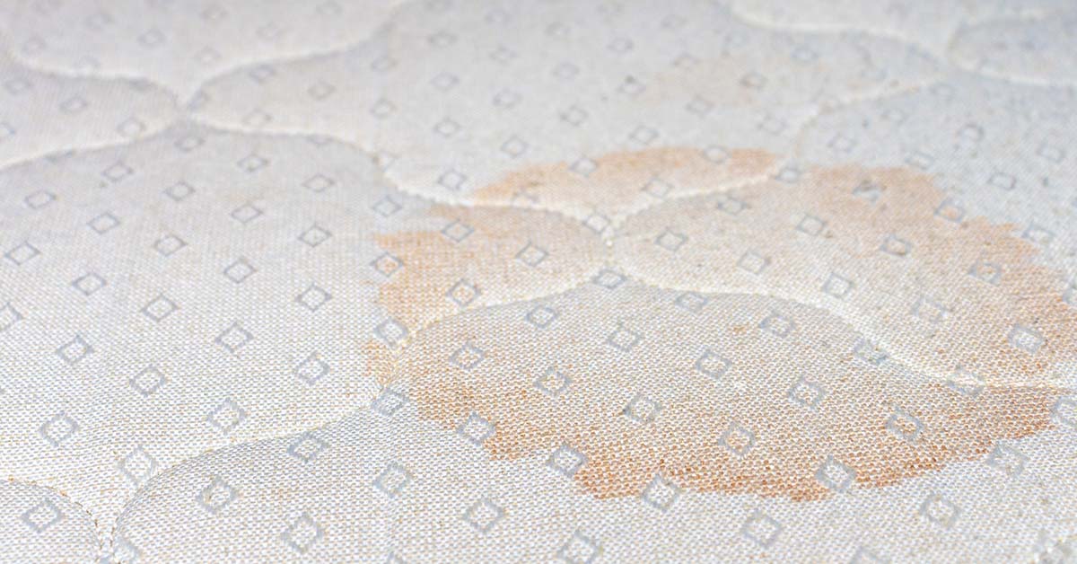 circular pinkish stain on a mattress