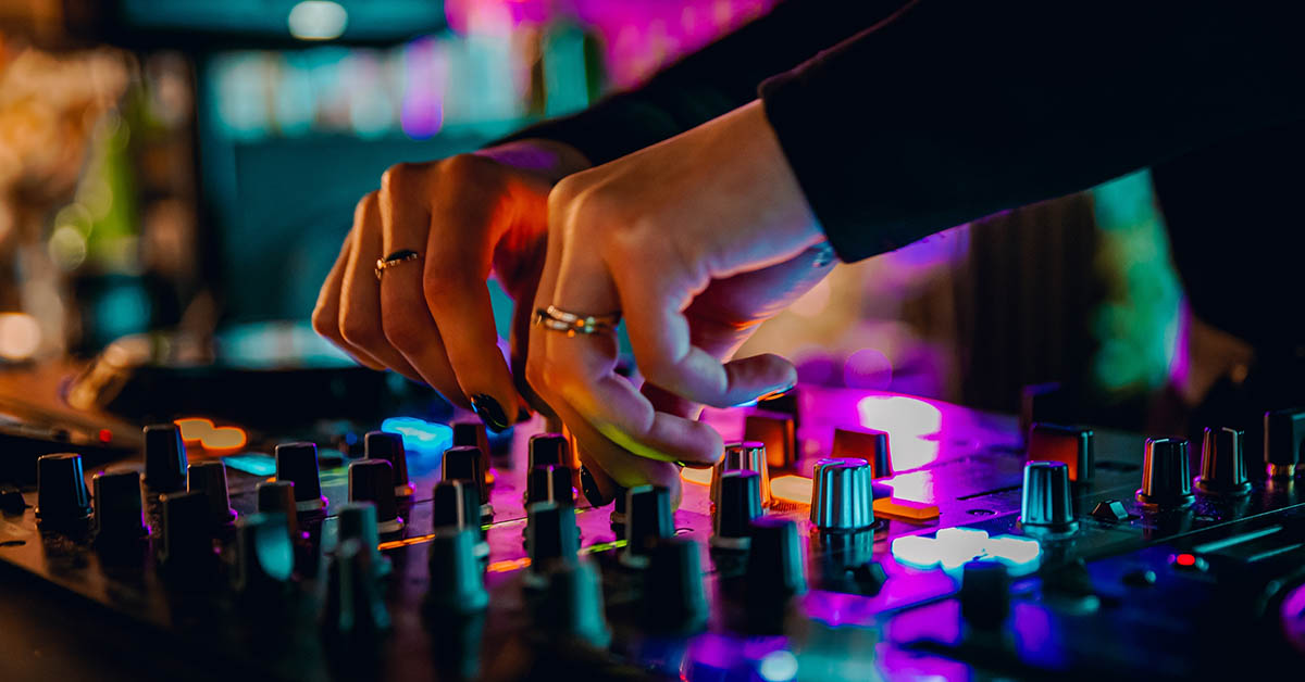 Dj adjusting controls on console