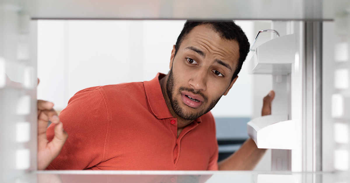 man opening fridge door