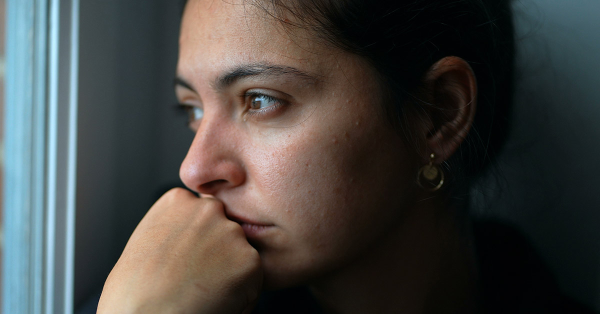 close up. woman looking out window.
