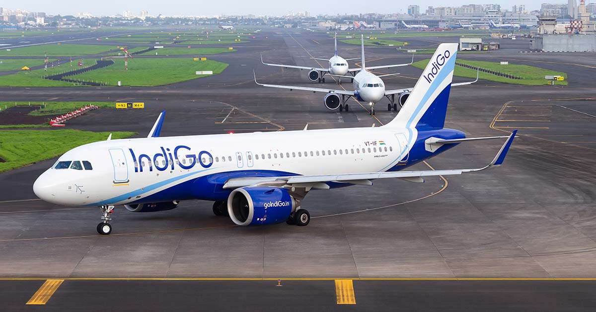line of airplanes taxiing along an airport runway