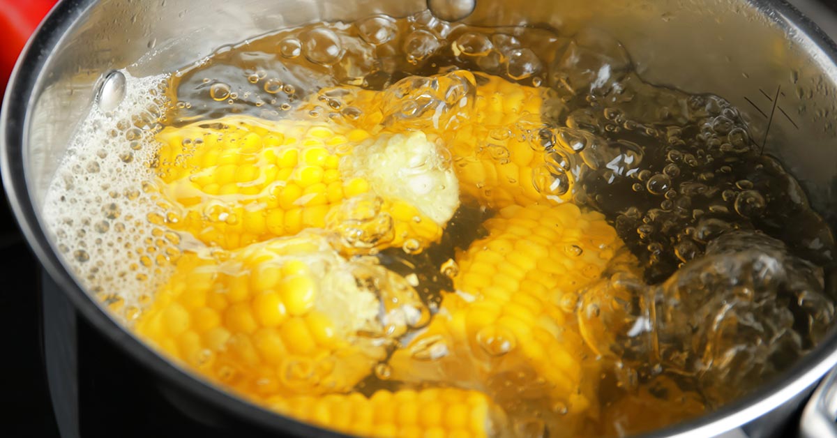 corn being boiled in a metal pot