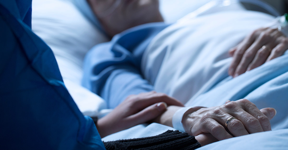 person laying in hospital bed. Hospice/dying concept