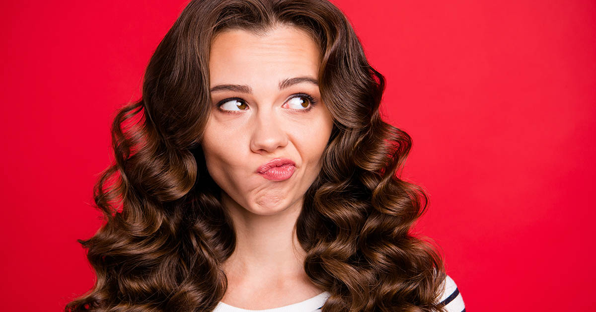 Close up portrait of attractive perfect hairdo she her girl looking up to empty space wondering not sure if did right way white striped pullover isolated on red vivid background