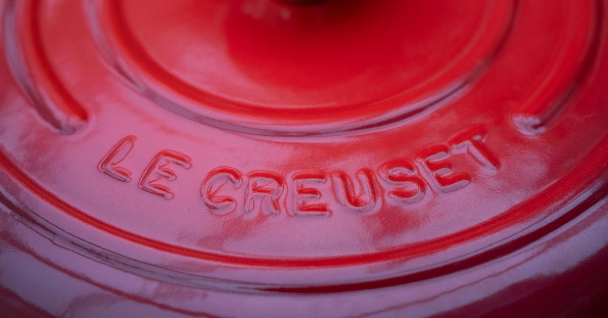 Close up top to a red Le Creuset Dutch oven