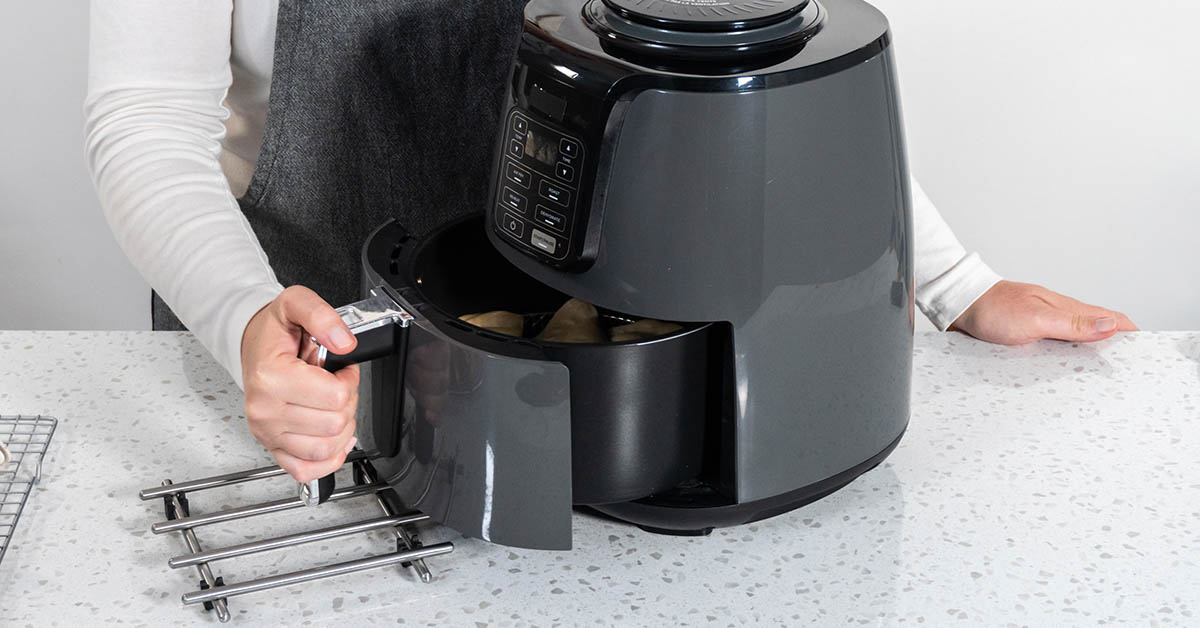 Person using air fryer