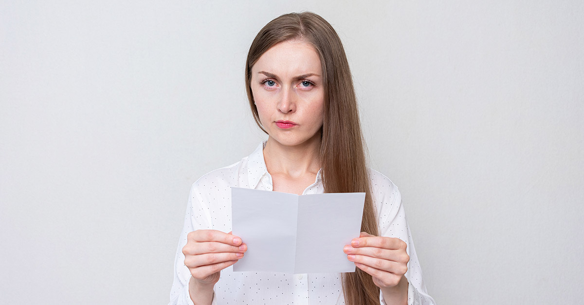 woman holding white piece of paper