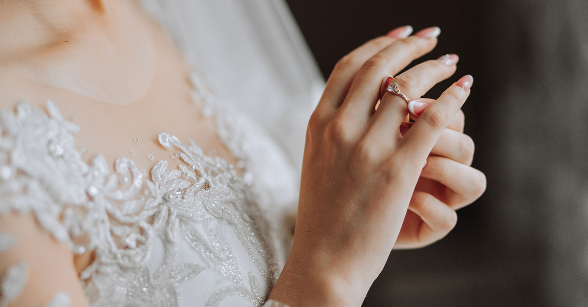 bride touching her wedding ring while on her hand