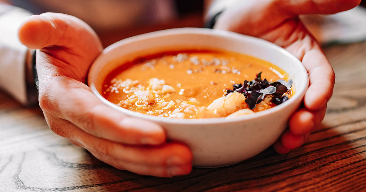 person holding bowl of soup
