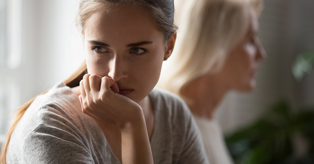 adult daughter turning away from her mother in conflict