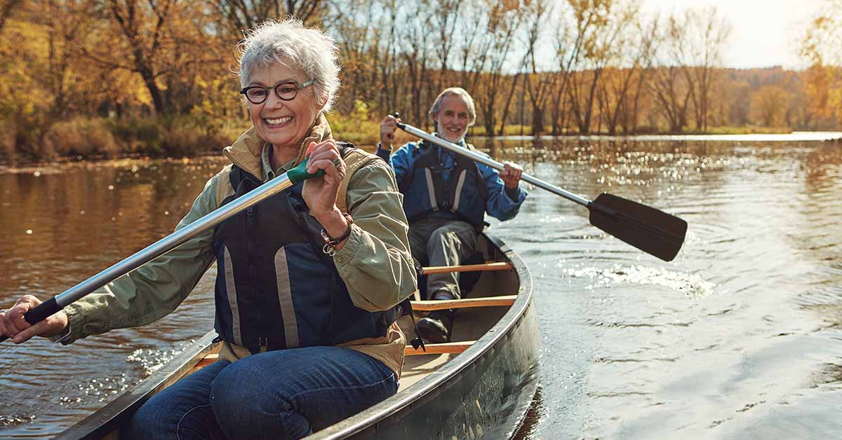 elderly couple canoeing. Happy retirement concept