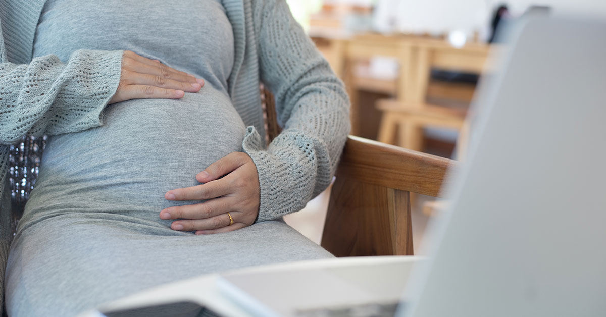 pregnant woman holding her stomach