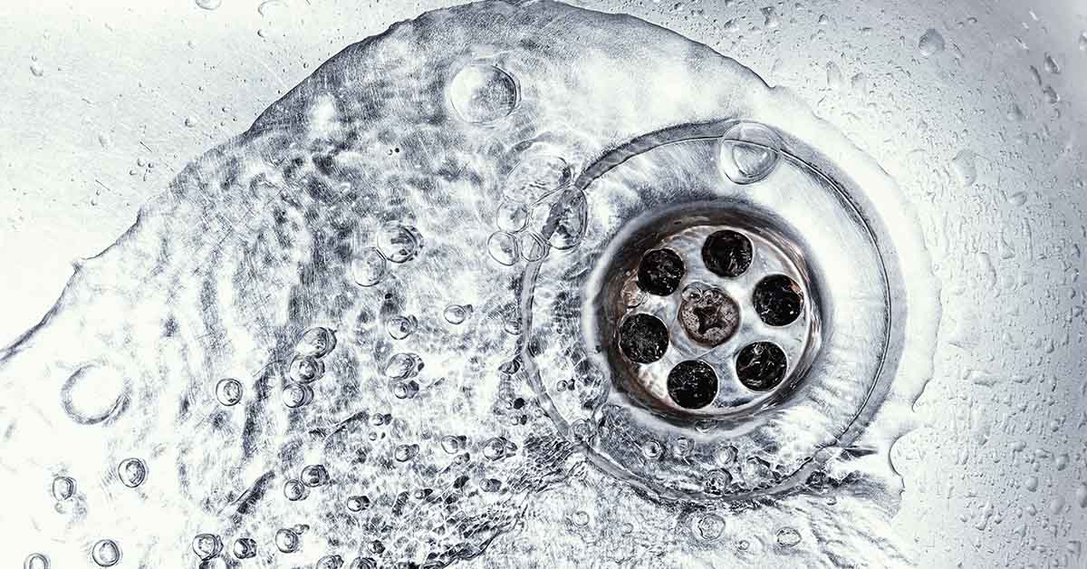 water going down drain in stainless steel sink