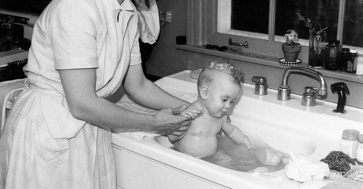vintage photograph mother bathing baby