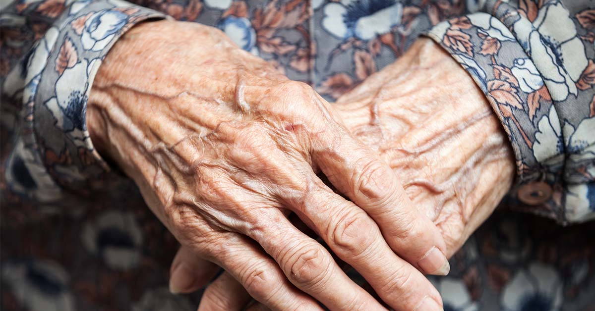 elderly woman's hands clasped together