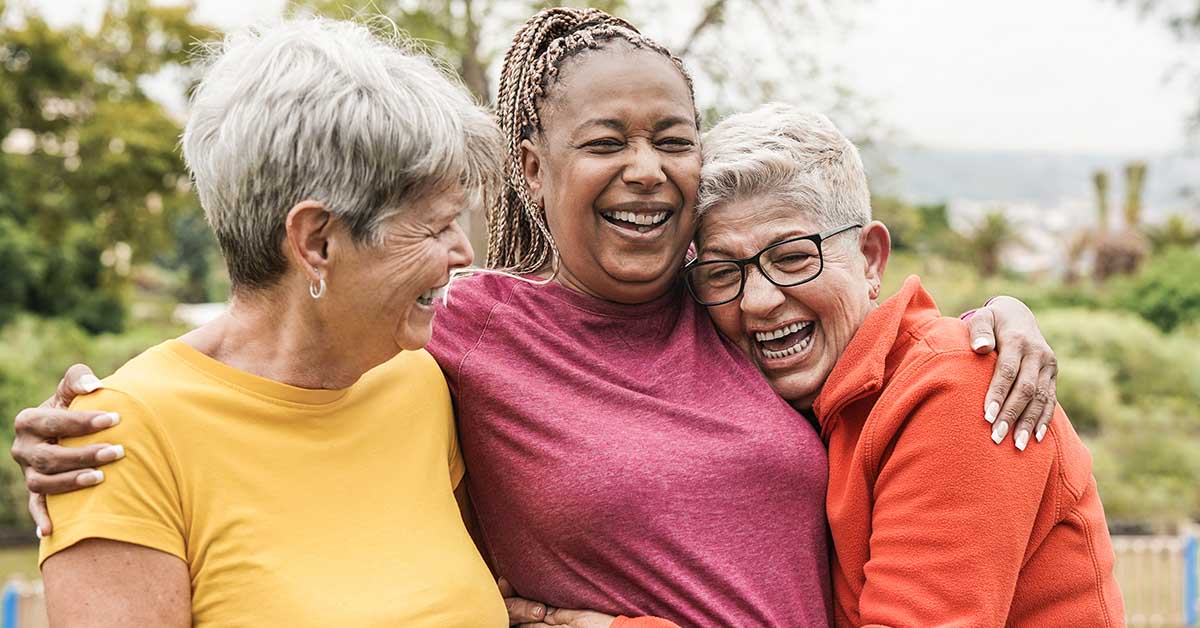 3 middle aged female friends embracing