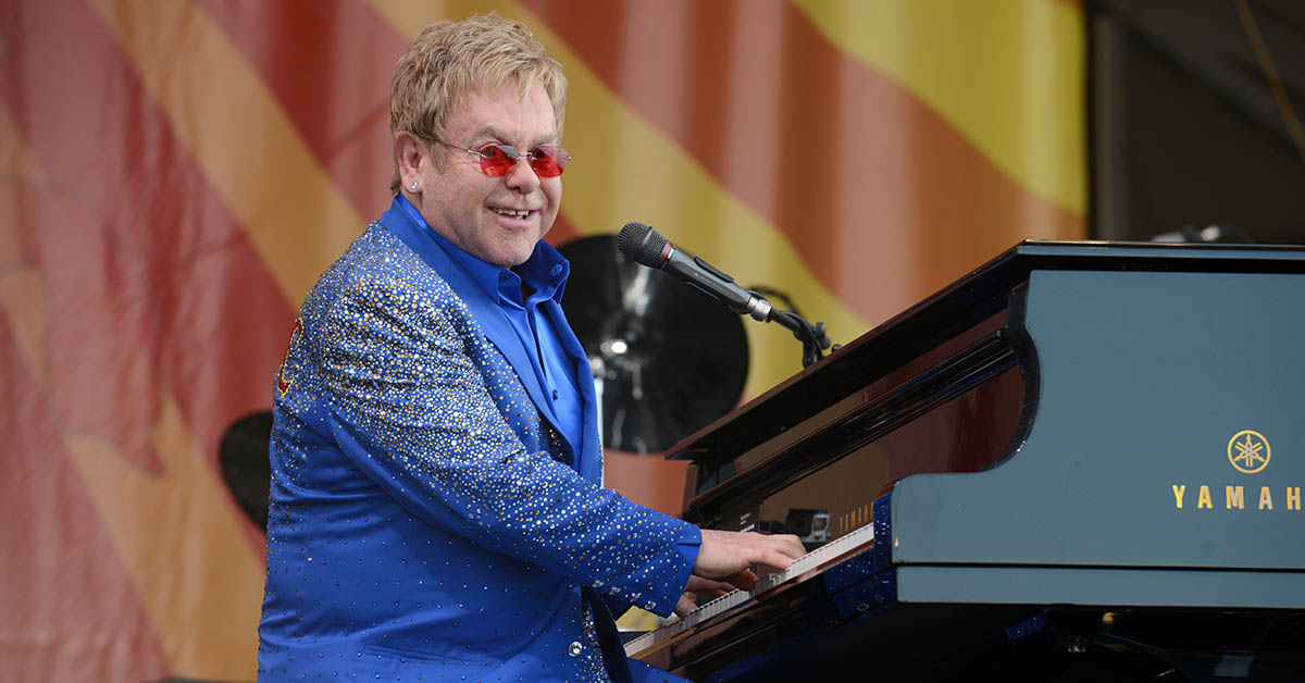 Elton John playing piano while performing