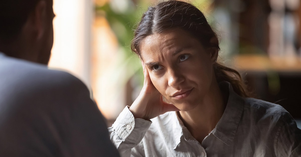 Woman appearing bored, while talking with someone