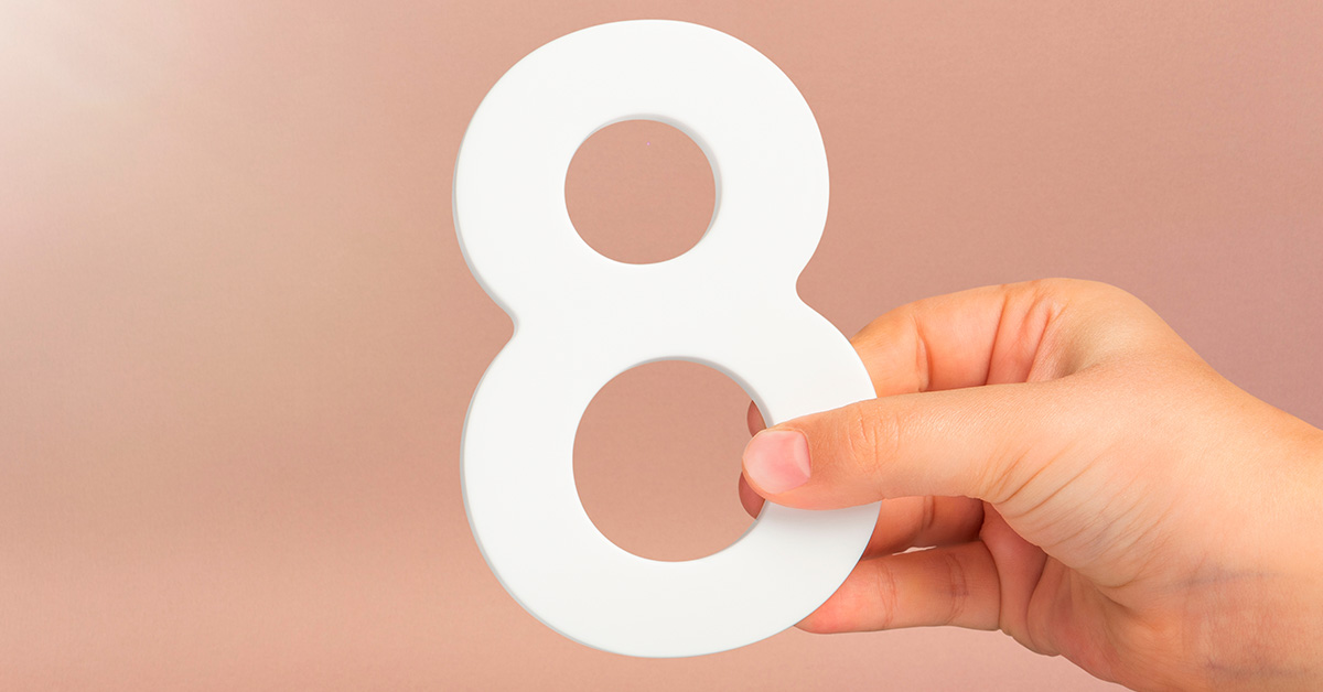 white number 8 held by hand
