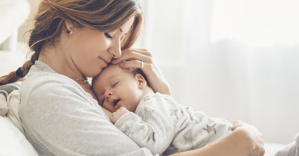 mother embracing her new born baby