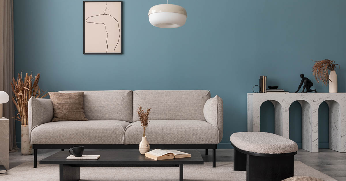 living room with grey couch and blue walls