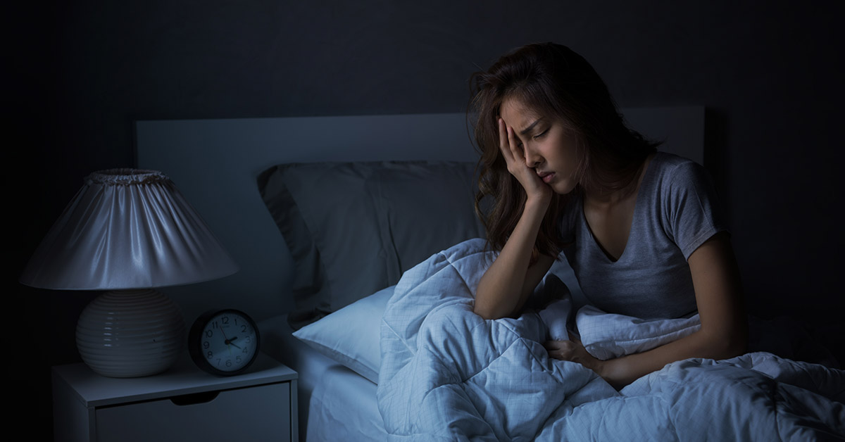 woman awake in bed in middle of the night suffering from poor sleep. Nightmare concept