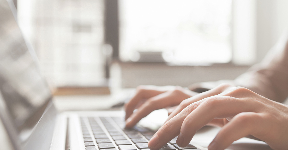 person typing on laptop
