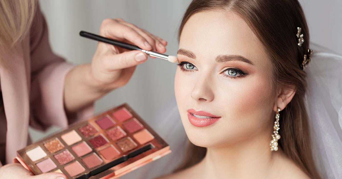 woman getting her make up done by a makeup artist
