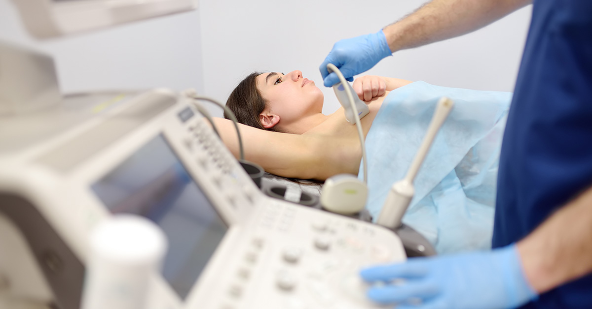 woman getting an ultrasound. Breast cancer screening concept