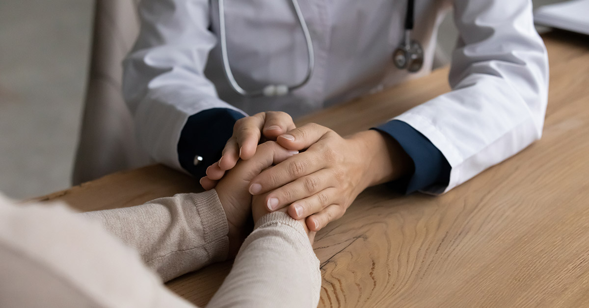 doctor holding the hands of someone else. Comforting them