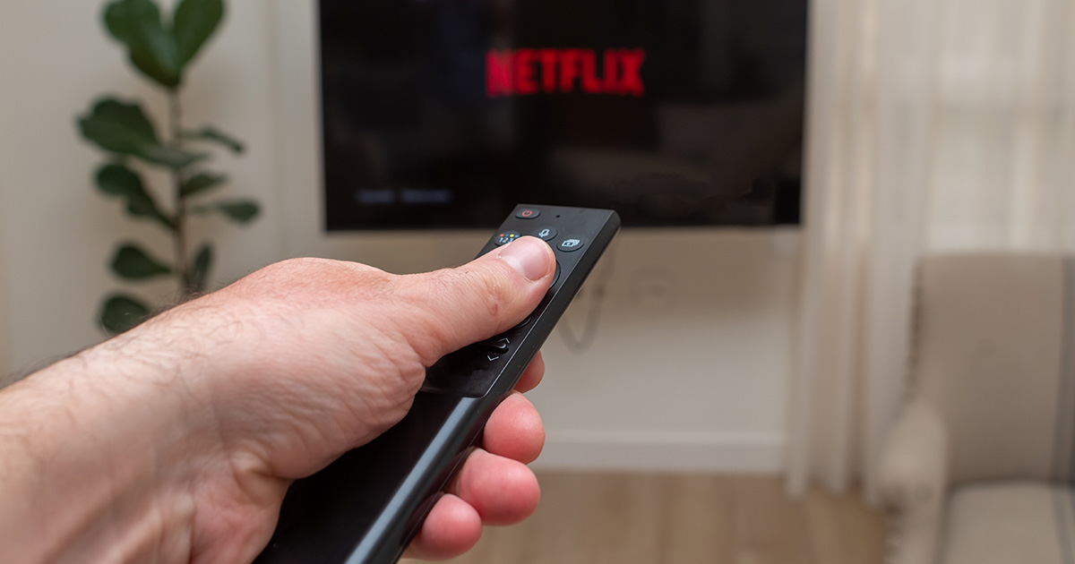 remote pointing at television with Netflix displayed on it