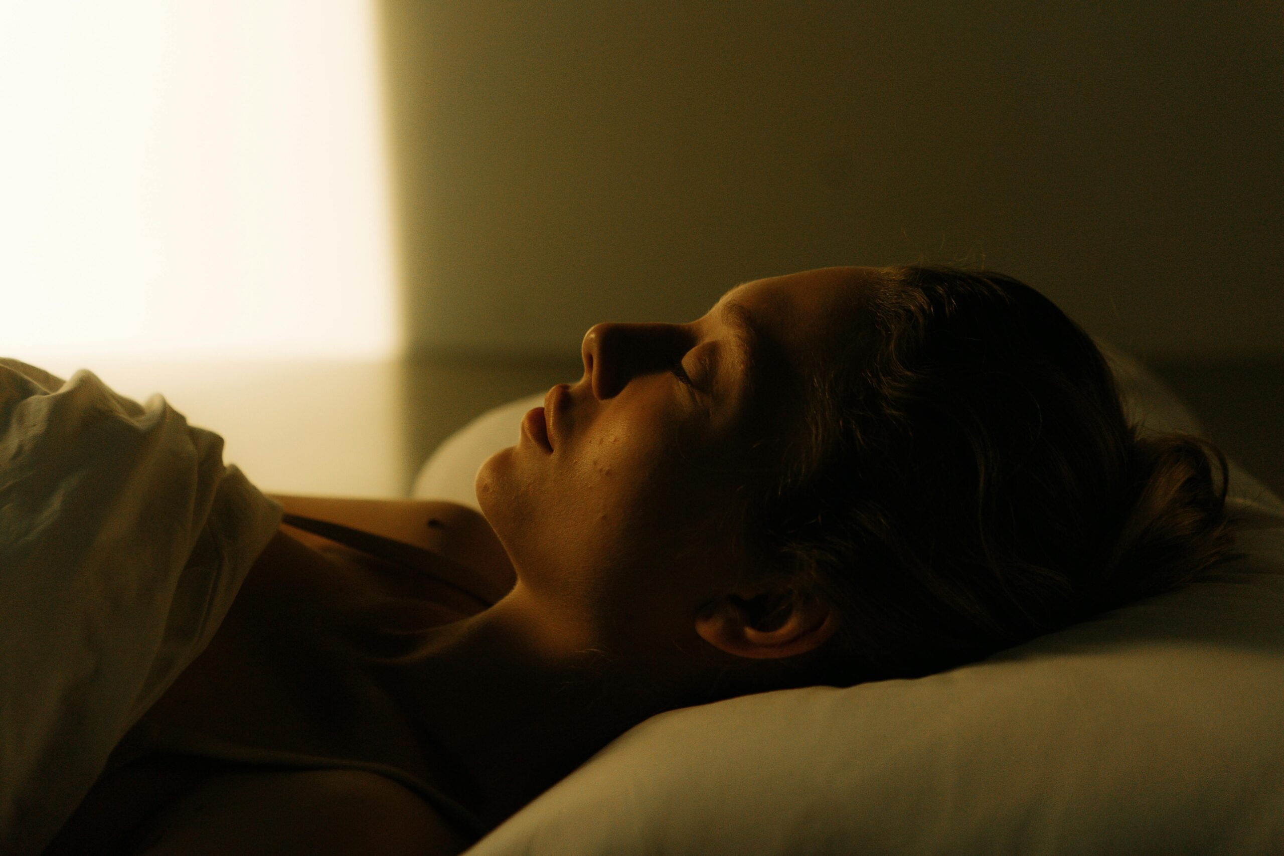 Photo of a Woman Sleeping on the Bed