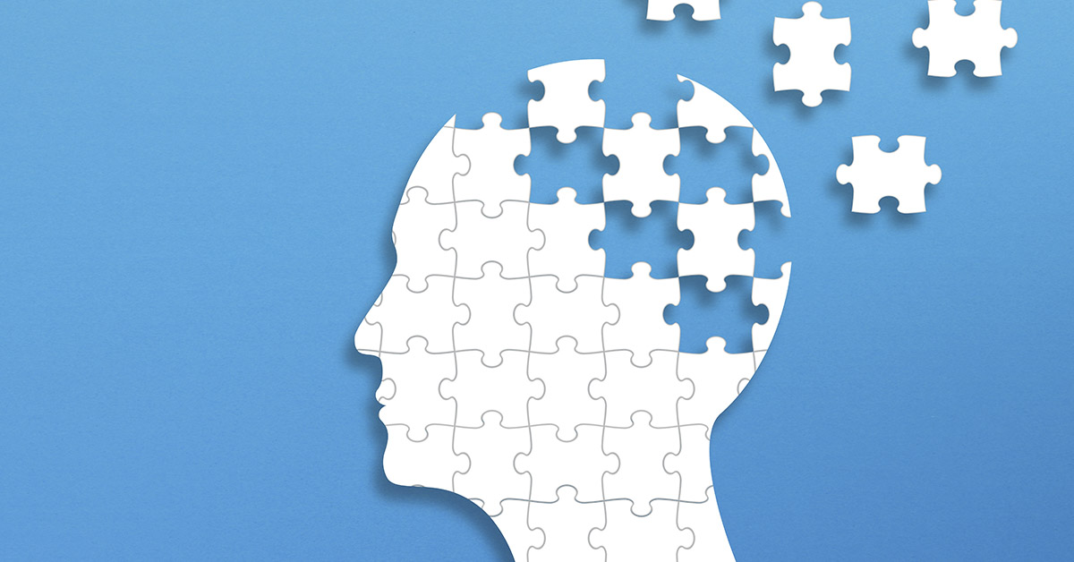 profile of a human head as a puzzle with various pieces breaking away. Dementia and cognitive health concept